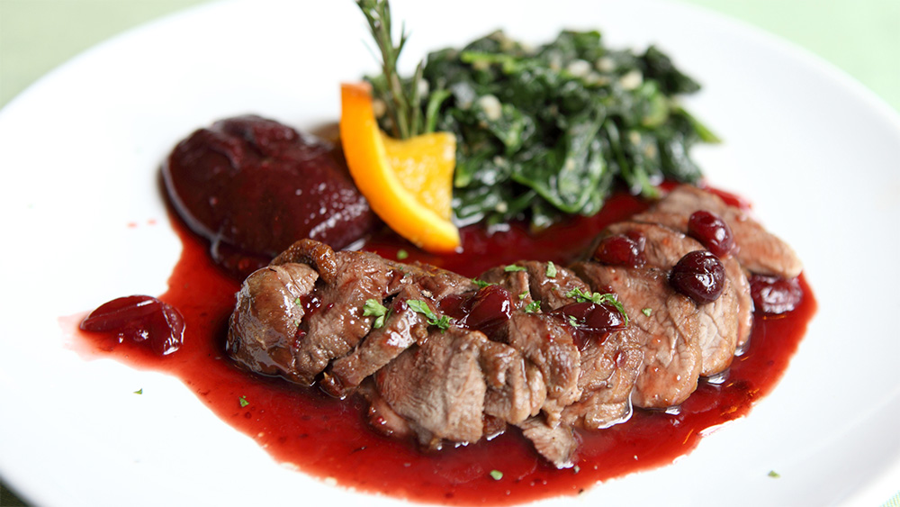 Plate with delicious duck legs and beetroot relish